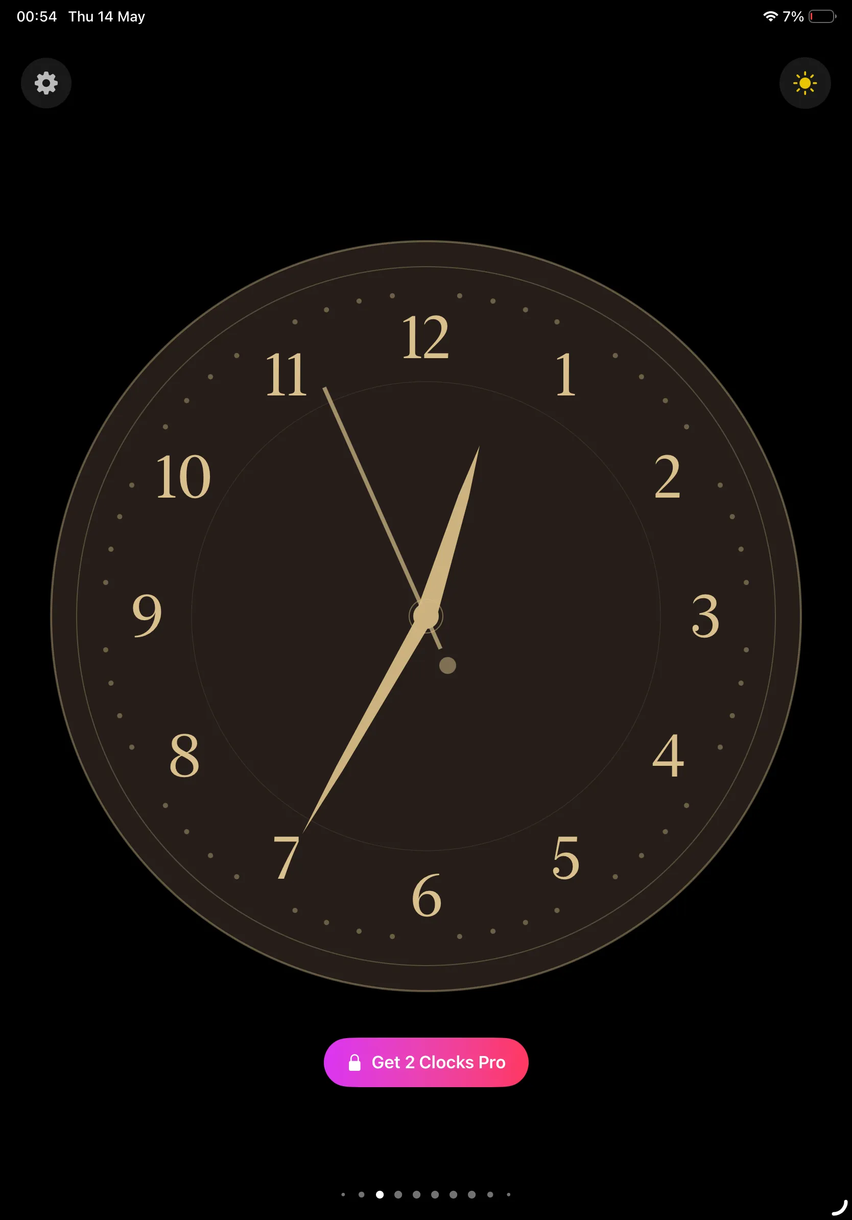 Elegant gold-and-cream analog clock on a black background on iPad